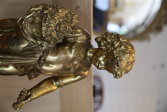 A pair of ormolu figures of putti holding flowers and a sickle, height 20.5in. diameter of bases 8in.